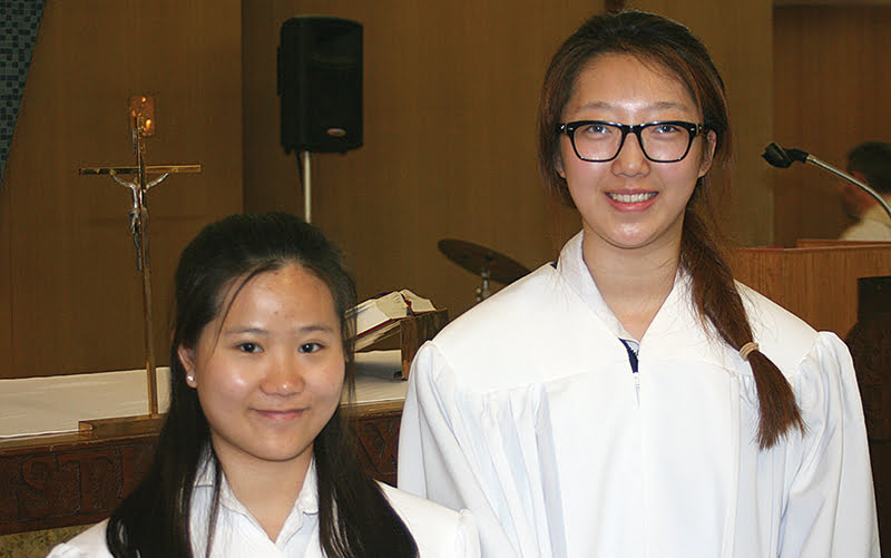 From left, Xuemeng “Rona” Chen and Lingfei “Bonnie” Kong were recently baptized Catholic. Coming from China, the two had no religious background before taking classes at Maur Hill-Mount Academy.