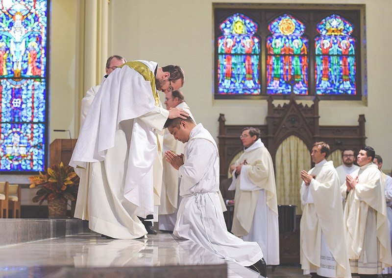 Father Mirco Sosio, AVI, expresses the unity of the presbyterate by imposing his hands on newly ordained Father Gerard Alba. Father Alba was ordained Nov. 15 at the Cathedral of St. Peter in Kansas City, Kansas. 
