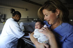 Leaven photo by Elaina Cochran Lisanne Milford (right), a nurse at Shawnee Mission Medical Center, gets to know baby Julaya Bradley as new mom Ciera Williams gets ready to take her daughter home. Milford was recognized in September for excellence in the workplace at the FIRE in the Workplace Honors Banquet. The Integrity Resource Center presents the awards to recognize people in the community who are honoring God through their work.