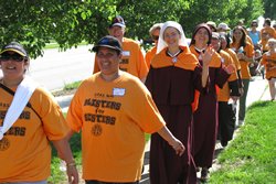 Hundreds of walkers take part in the sixth annual “Blisters for Sisters” walkathon at Church of the Nativity Parish in Leawood. With the money raised from the event, 19 communities will receive $1,000 each. By John Heuertz.