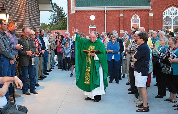 PHOTO COURTESY OF TODD SHEPPARD Father Pat Sullivan, pastor of St. Columbkille Parish in Blaine, blesses the parish’s new church hall on Sept. 29. With the whole parish community pitching in, the church hall was completed in record time.
