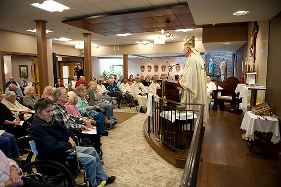 Although the chapel has a few pews that were formerly at St. Agnes Parish in Roeland Park, the majority of the space was designed for folding chairs and to accommodate wheelchairs, since many Villa residents have difficulties with mobility. The chapel, which is located to the left off the facility’s main entrance, is open for daily Mass and individual prayer all hours on all days. Photo by Joe Bollig.