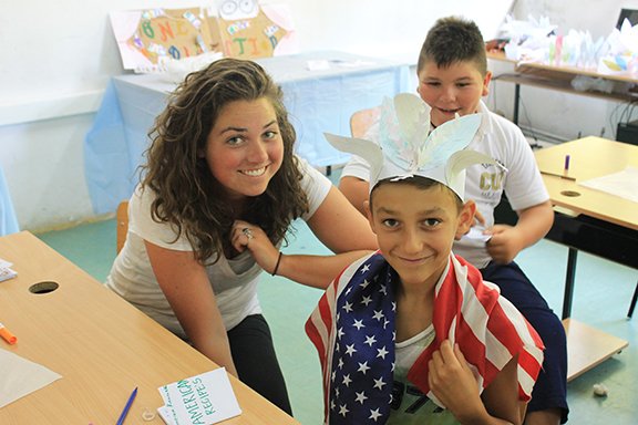 Shannon Feehan poses with a couple of her students in the village of Peshtani in the Republic of Macedonia, a country in the central Balkan peninsula in southeast Europe. Feehan, a 2007 graduate of St. Thomas Aquinas, has been serving with the Peace Corps in Macedonia since 2011.