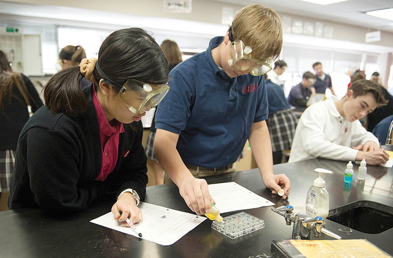 From left, Bishop Miege sophomores Alyssa Yap, Luke McCool and Landry Weber work on a lab project.