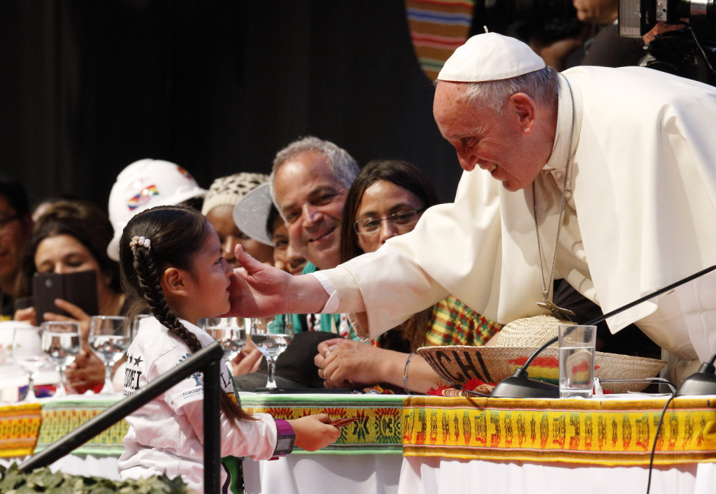 Pope Francis greets a young girl as he participates in the second World Meeting of Popular Movements in Santa Cruz, Bolivia, July 9. (CNS photo/Paul Haring)