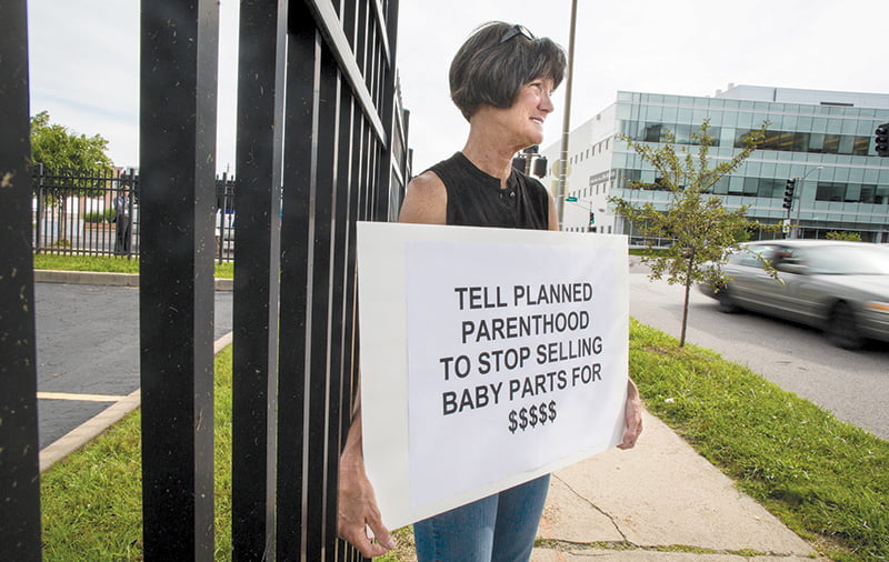 Bev Ehlen, state director of Concerned Women for America, holds a sign outside of a Planned Parenthood facility in St. Louis July 21. She was among several pro-life supporters demonstrating after the release of two videos that showed Planned Parenthood officials discussing the method and price of providing fetal tissue obtained from abortions for medical research. CNS photo/Lisa Johnston, St. Louis Review
