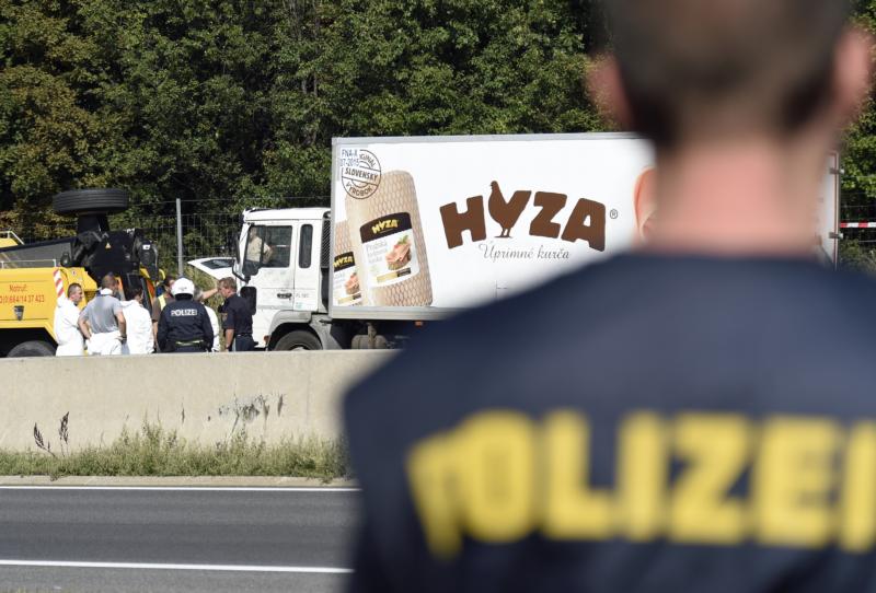 Forensic experts investigate a truck in which refugees were found dead on a freeway between Parndorf and Neusiedl, Austria, Aug. 27. (CNS photo/Herbert P. Oczeret)  
