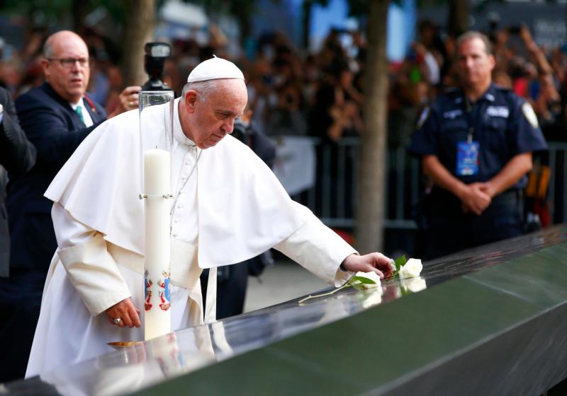 Pope Francis places a rose at the South Pool of the National 9/11 Memorial and Museum Sept. 25 in New York. (CNS photo/Tony Gentile)
