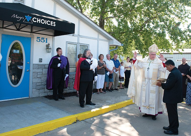 Leaven photo by Joe McSorley Archbishop Joseph Naumann blesses and dedicates the new home of Mary’s Choices, located in north Topeka. Mary’s Choices is a nonprofit agency dedicated to helping women facing unplanned pregnancies.