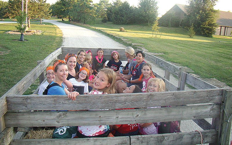 Photo courtesy of Prairie Star Ranch A group of American Heritage Girls take a cart tour of Prairie Star Ranch during a retreat at the camp near Williamsburg.