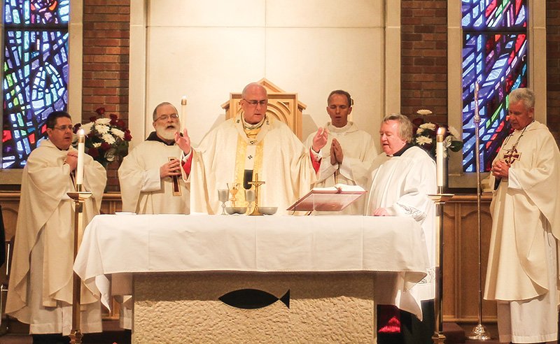 Archbishop Joseph Naumann celebrates the 25th anniversary Mass of the Didde Catholic Campus Center in Emporia on Nov. 14. Pictured with the archbishop are, from left, Father Ray May; Father Curtis Carlson, OFM Cap.; Father Nick Blaha; Msgr. Gary Applegate; and Father Bill Porter. 