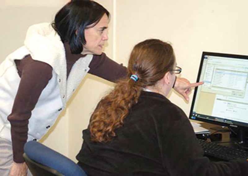Leaven photo by Jill Ragar Esfeld In its new Kansas City, Kansas, location provided by Catholic Charities of Northeast Kansas, Bishop Sullivan Center is helping those struggling to find employment. As a first step toward that goal, Kathleen Kennedy, manager of Employment Services and Emergency Assistance, schedules new clients for job skills orientation.