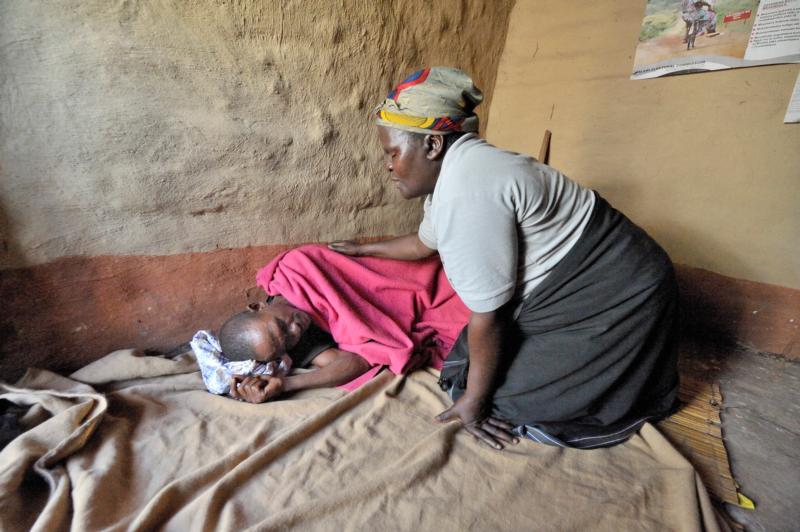 Home-based care worker Olipa Mkandawire prays for a man living with AIDS in Matuli, Malawi, in this 2009 photo. Marking World AIDS Day Dec. 1, African bishops commended families and parishioners caring for people with HIV as the Year of Mercy approaches. (CNS photo/Paul Jeffrey)