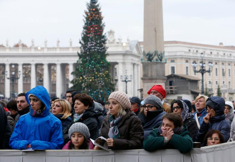 People attend Pope Francis' celebration of the opening Mass of the Holy Year of Mercy in St. Peter's Square at the Vatican Dec. 8. (CNS photo/Paul Haring)