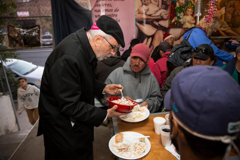 Bishop Gerald F. Kicanas of Tucson, Ariz., serves men at the "comedor," the kitchen and dining hall of the Aid Center for Deported Migrants in Nogales, Mexico, Dec. 20.  Bishop Kicanas and Nogales Bishop Jose Leopoldo Gonzalez Gonzalez visited with migrants after taking part in a binational "posada," a commemoration of Mary and Joseph’s search for a place to give birth to Jesus. (CNS photo/Nancy Wiechec)