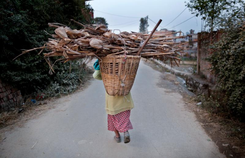 A Nepalese woman carries firewood on her back as she returns home in Lalitpur Dec. 21. The church in Nepal is preparing for a bleak Christmas as the Himalayan nation passes through one of the worst crisis in its history following the April 25 earthquake and an Indian blockade. (CNS photo/Narendra Shrestha, EPA)