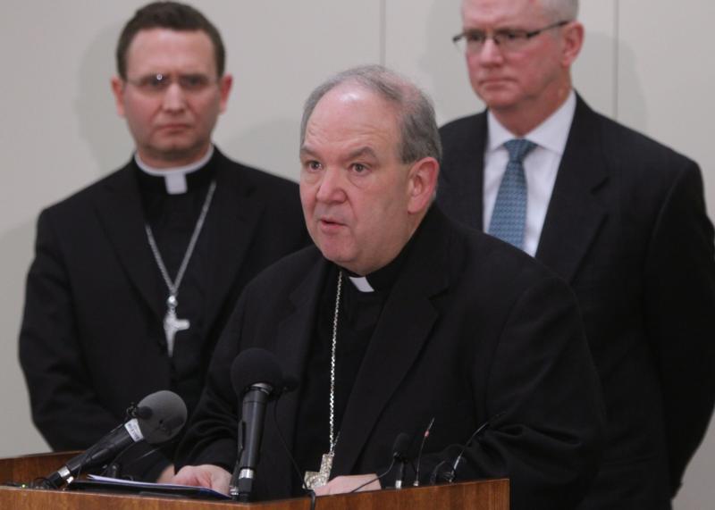 Archbishop Bernard A. Hebda speaks at a news conference following the Dec. 18 filing of a settlement agreement between the Archdiocese of St. Paul and Minneapolis and the Ramsey County Attorneys Office. After the Nov. 15 shooting death of Jamar Clark, a black man, by a white police officer, Catholics in north Minneapolis hope to pave path to peace. (CNS photo/Dave Hrbacek, The Catholic Spirit)