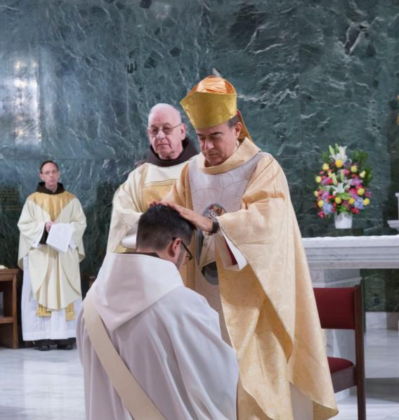 Archbishop Roberto Octavio Gonzalez Nieves of San Juan, Puerto Rico, lays his hands on the head of Franciscan friar Michael Reyes, during his Jan. 16 ordination at St. Francis of Assisi Church in in the Manhattan borough of New York. (CNS photo/Octavio Duran)