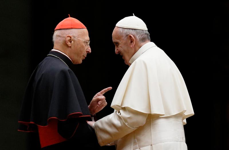 Cardinal Angelo Bagnasco, president of the Italian bishops' conference, talks with Pope Francis during a prayer vigil for the Synod of Bishops on the family in St. Peter's Square at the Vatican in this Oct. 3, 2015, file photo. Cardinal Bagnasco said Italy's bishops are united in reaffirming the rights of children to be raised by a mother and father. His comment came as the Italian Senate is set to vote Jan. 28 on legislation that would allow civil unions for heterosexual and homosexual couples. (CNS photo/Paul Haring)
