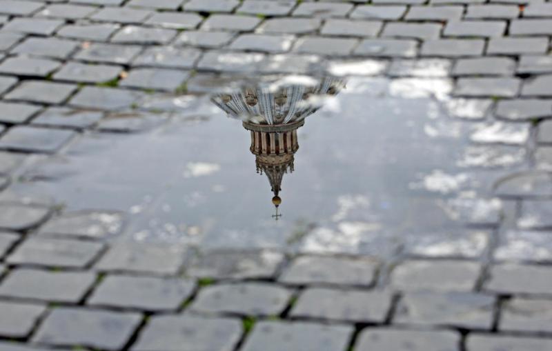 In this 2013 file photo, St. Peter's Basilica is reflected in a puddle of water at the Vatican. (CNS/photo Alessandro Di Meo, EPA)