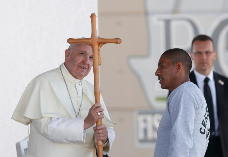 Pope Francis accepts a crucifix from a prisoner as he visits Cereso prison in Ciudad Juarez, Mexico, Feb. 17. (CNS photo/Paul Haring)