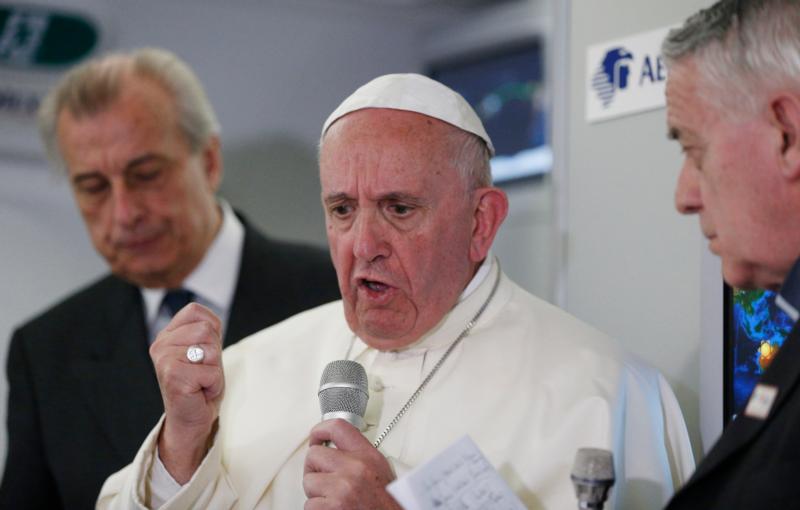 Pope Francis answers questions from journalists aboard his flight from Ciudad Juarez, Mexico, to Rome Feb. 17. (CNS photo/Paul Haring)