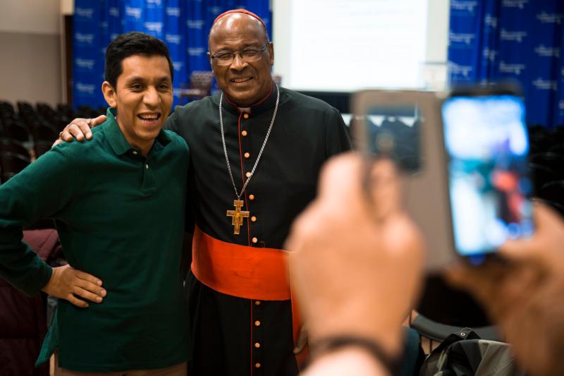Cardinal Wilfrid Napier of Durban, South Africa, poses for a photo with an attendee of his lecture at The Catholic University of America in Washington, Feb. 17. (CNS photo/Tyler Orsburn)