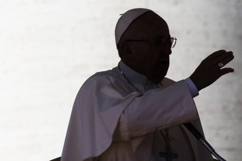 A silhouette of Pope Francis is seen in St. Peter's Square at the Vatican Feb. 20. For a Christian, talk is cheap; the faith requires concretely doing God's will and serving the least as well as those around you, Pope Francis said at his morning Mass Feb. 23.(CNS photo/Angelo Carconi, EPA)