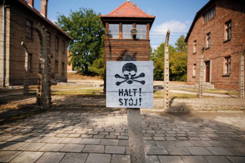 A guard tower is seen beyond on area enclosed with barbed wire at the Auschwitz-Birkenau Memorial and State Museum in Oswiecim, Poland. The Auschwitz memorial and museum is setting aside days exclusively for World Youth Day pilgrims who want to tour the former Nazi death camp. (CNS photo/Nancy Wiechec)
