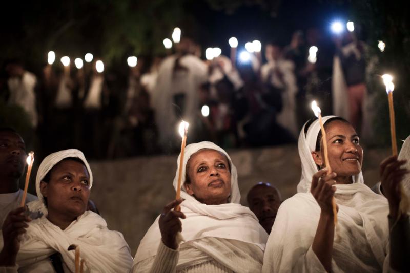 Ethiopian Orthodox Christians light candles and pray during the Holy Fire ceremony in Jerusalem's Church of the Holy Sepulcher in this April 19, 2014, file photo. (CNS photo/Abir Sultan, EPA)