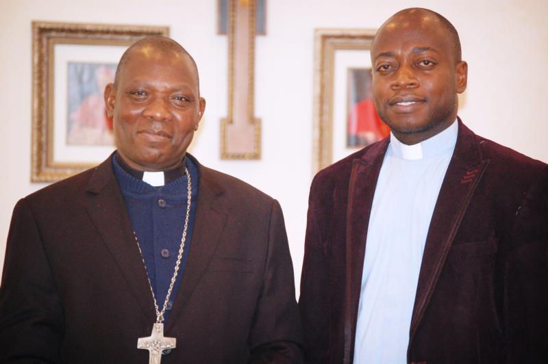 Bishop Oliver Dashe Doeme of Maiduguri, Nigeria, and Father Gideon Obasogie, also from Nigeria pose for a photo March 11 at St. Francis de Sales Seminary in Wisconsin. (CNS photo/Ricardo Torres, Catholic Herald)