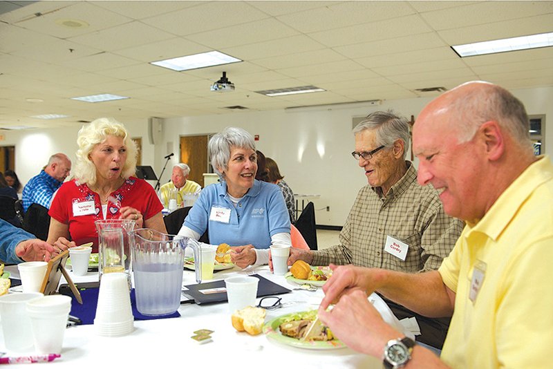Leaven photo by Joe Bollig ChristLife members (from left) Charlotte Doyle, Linda Beck, Bob Cordry and Mike Grothof dine together at the final session of the first Discovering Christ module at Prince of Peace Parish in Olathe.