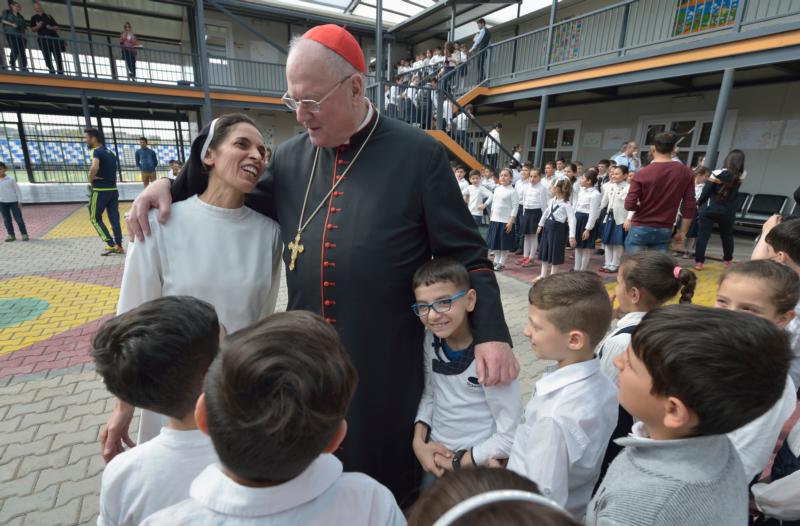 Cardinal Timothy M. Dolan of New York embraces Dominican Sister Muntahah Haday at the Al Bishara School run by the Dominican Sisters of St. Catherine of Siena in Ankawa, Iraq, April 9. (CNS photo/Paul Jeffrey)