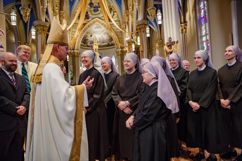 Bishop Kevin C. Rhoades of Fort Wayne-South Bend, Ind., greets members of the Little Sisters of the Poor at the Basilica of the Sacred Heart at the University of Notre Dame in Indiana April 9. The congregation was awarded the Evangelium Vitae Award for outstanding service to human life, presented annually since 2011 by the university's Center for Ethics and Culture. (CNS photo/Peter Ringenberg, Notre Dame Center for Ethics and Culture)