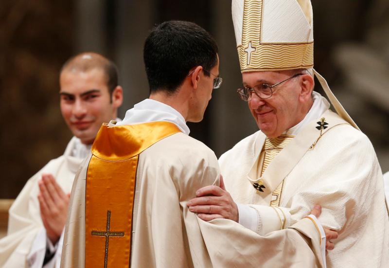 Pope Francis greets a new priest during the ordination Mass of 11 priests in St. Peter's Basilica at the Vatican April 17. Nine were ordained for the Diocese of Rome and two for the Rogationist religious order. (CNS photo/Paul Haring)