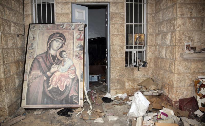 A painting of Mary and the Christ Child is is seen in 2014 at the damaged St. Thecla Orthodox monastery in the predominantly Christian town of Maaloula, Syria. Russia's Catholic Church has launched a joint project with Russian Orthodox leaders to rebuild churches and monasteries destroyed during the war in Syria. (CNS photo/Youssef Badawi, EPA)