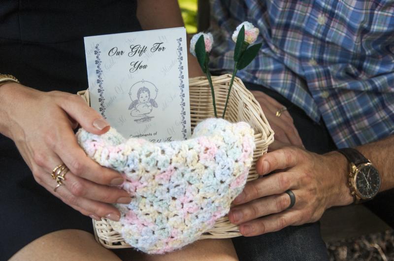 Kayla Boesch and her husband, Matt, of Clarksville, Tenn., hold a basket of momentos they received at the hospital honoring their deceased baby Sept. 23. Kayla suffered a miscarriage earlier this year and wants to break the silence surrounding miscarriages by talking about her experience and sharing resources with other women. (CNS photo/Theresa Laurence, Tennessee Register) See MISCARRIAGE-LOSS Oct. 20, 2016.