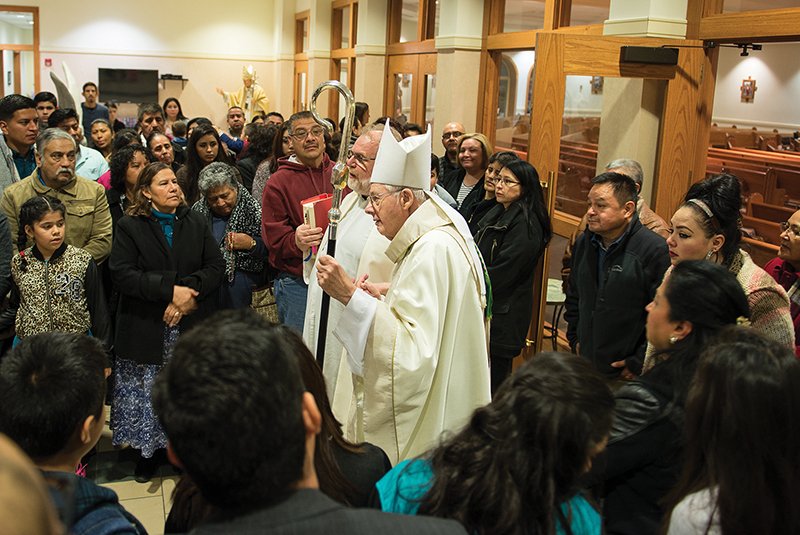 Archbishop Emeritus James P. Keleher, assisted by Father Gianantonio Baggio, CS, greets participants in the final Year of Mercy pilgrimage, held at Divine Mercy Church in Gardner, after celebrating Mass in Spanish for them. PHOTO BY JOE BOLLIG