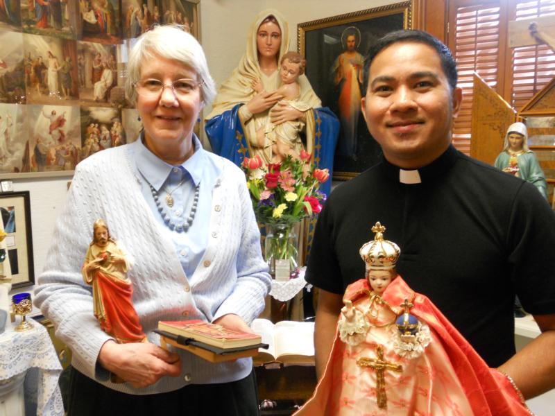 Jan Marie Shannon and Father Al Benedick Taguinod of the Missionaries of Our Lady of La Salette in the Philippines, pose with religious figures April 12 at Shannon's Tilma shop in Berea, Ohio. (CNS photo/Jerri Donohue)